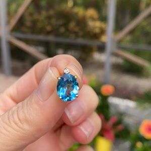 Beautiful Blue Topaz stud - hold by gold frame & small diamond on top.